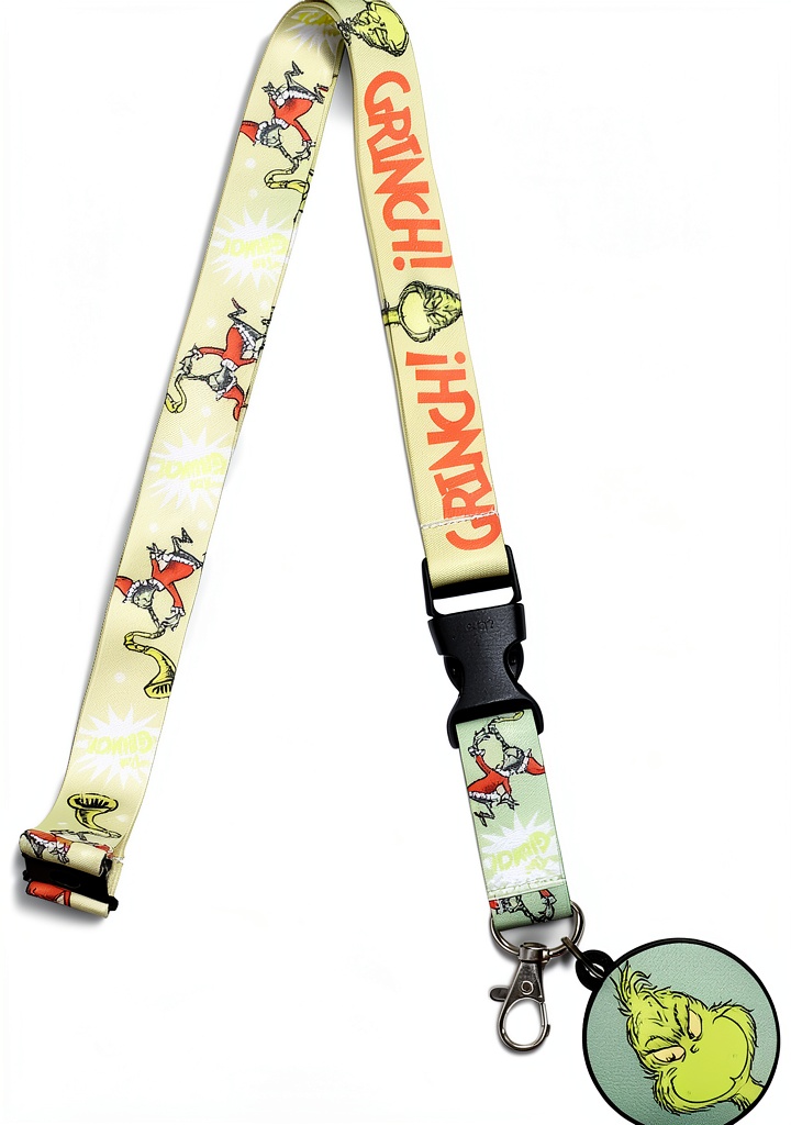 The Grinch badge lanyard displayed on a desk with office supplies